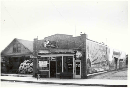 480: The Village Rendezvous was on the west side of Highway 101 downtown Encinitas between D and E Streets. The picture was taken in the late 1930's, because the highway is shown already widened. The building to the left of the Rendezvous is the original Lux home and is where Mary (Lux) Rathyen and her husband? Warner lived. He owned Rathyen Realty Co. Mr. Rathyen was also Postmaster in the early years of Encinitas. The house was later moved to the west side of Second St. between F and G Streets.
