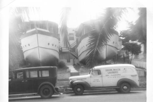 506: Encinitas Boat Houses circa 1956. 1930s Ford & 1,940s Chevrolet, Panel Truck, (Snow White Laundry), in front of Twin Boat Houses. Encinitas, CA. 

