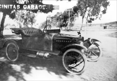 851: Del Mar Historical Collection, EN-11. Rathyen Garage with Herb Estes car, circa 1914. Used as a bus after flood in 1916. Estes married Sylvia Lauer.
